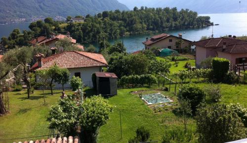 a house on a hill with a lake in the background at Casa Lidia in Ossuccio