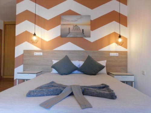 a bedroom with a large bed with a wooden headboard at Chabela's Suites in La Lajita