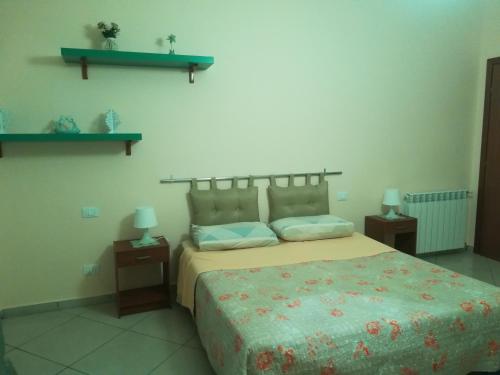 a bedroom with a large bed and two night stands at B&B Il Gabbiano in Reggio di Calabria