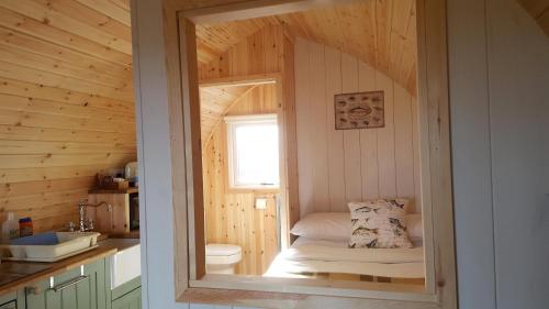 a small bathroom with a small bed in a room at Hillside Havens in Dufftown