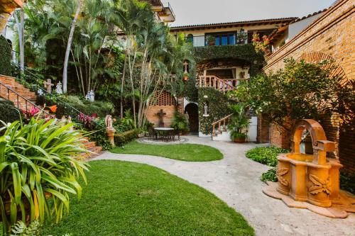 a backyard with a garden with a fire hydrant at Hacienda San Angel in Puerto Vallarta