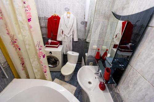 a bathroom with a white toilet and a sink at Five Stars Center City in Krasnoyarsk
