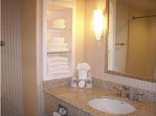 a bathroom with a sink and a mirror and towels at Holiday Inn Express Hotel & Suites Drums-Hazelton, an IHG Hotel in Drums