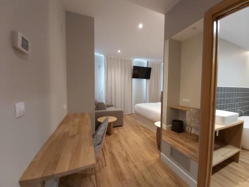 a room with a bed and a table in a room at Habital Suites in Jaca