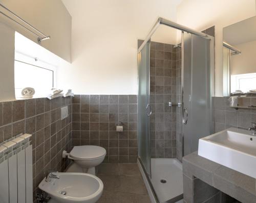 a bathroom with a toilet and a shower and a sink at Albergo Serena in Lerici