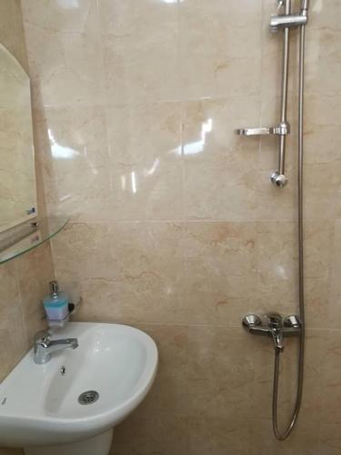 a bathroom with a sink and a shower at Слънчевата къща in Kovachevitsa