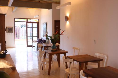 a dining room with wooden tables and chairs at Green 53 Boutique Hotel in Ilhéus