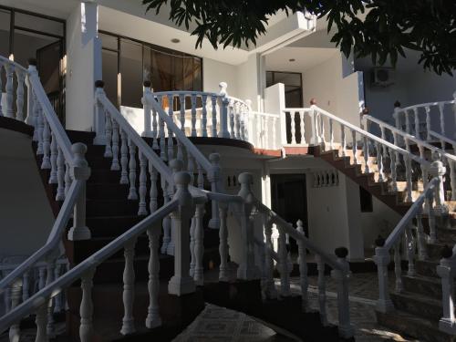 a staircase in a house with white railings at Hotel Restaurante Versalles in Melgar
