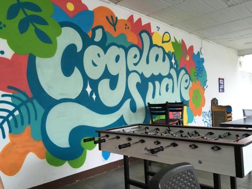 a room with a colorful wall with a pool table at Hotel Restaurante Versalles in Melgar