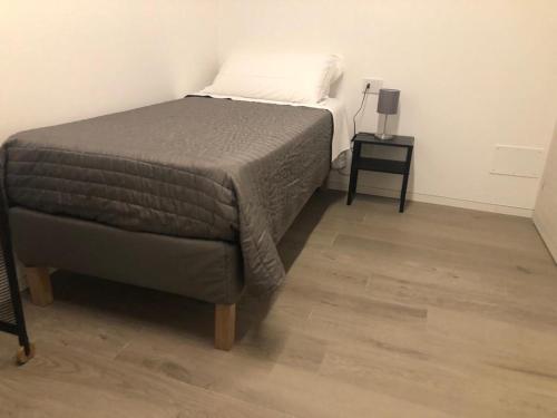 a bedroom with a bed and a side table at Ibisco Affittacamere in Iesi