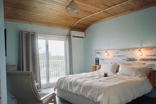 a bedroom with a large bed and a window at Deer Run on the Atlantic in Big Pine Key