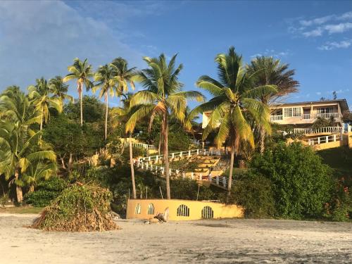 a resort on the beach with palm trees at CafeGourmetPtaCorona in San Carlos