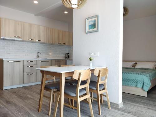a kitchen with a table and chairs and a bed at Green Line in Mtsvane Kontskhi