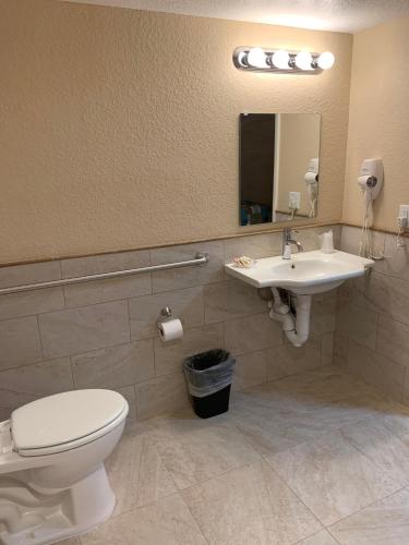 a bathroom with a toilet and a sink at Inn on the Gulf in Hudson