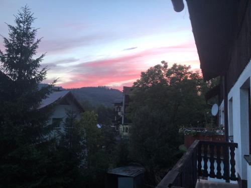 a view of a sunset from a balcony at Willa Katarzynka in Wisła