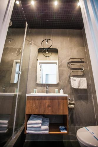 a bathroom with a sink and a mirror at E4 Hotel in Odesa