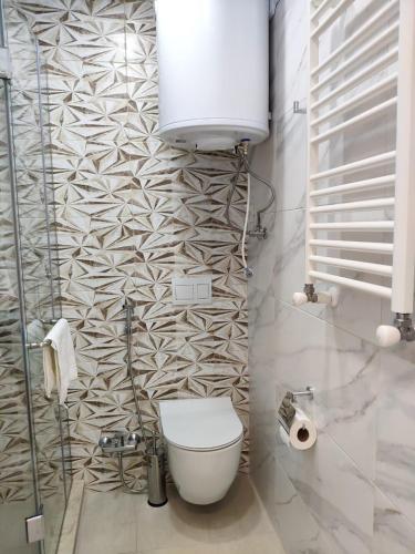 a bathroom with a toilet and a wall at Green Line in Mtsvane Kontskhi