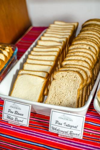 a row of sandwiches on a table with labels at Hotel Cusco Plaza Saphi in Cusco