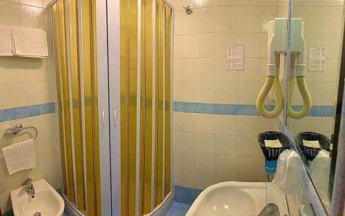 a bathroom with a shower and a sink at Hotel La Pergoletta in SantʼAgata sui Due Golfi