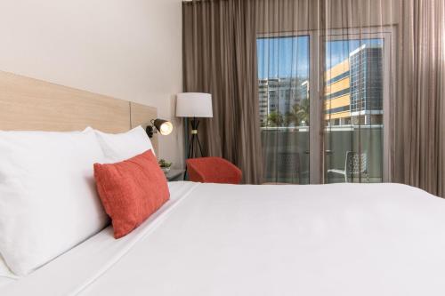 a hotel room with a large bed and a window at Verdanza Hotel in San Juan