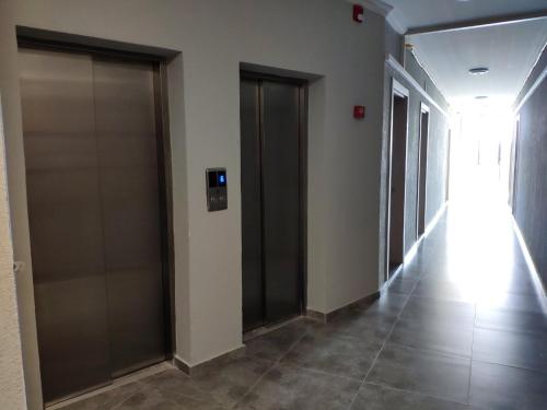 a hallway with two elevator doors in a building at Green Line in Mtsvane Kontskhi