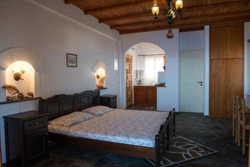 a bedroom with a large bed in a room at Niriides Studios in Armenistis