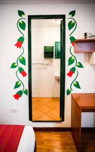a bathroom with a mirror and a toilet at Cusco Plaza Nazarenas in Cusco