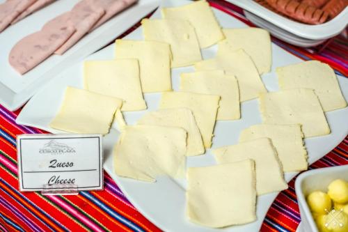 a plate of cheese on a table at Cusco Plaza Nazarenas in Cusco
