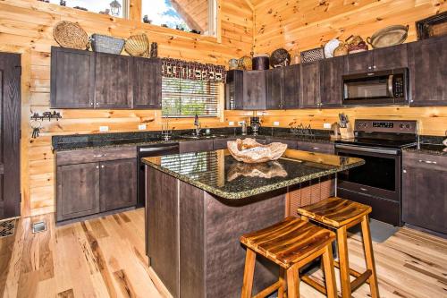 a kitchen with wooden cabinets and a center island with stools at Bella Vista Lodge in Gatlinburg
