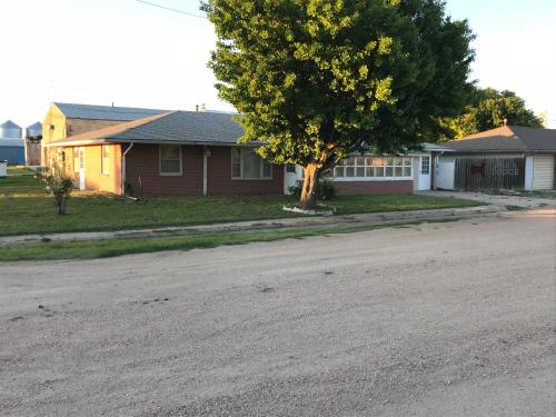 a house with a tree on the side of a street at Lodge 545 Complete Large brick house fully furnished in Agra