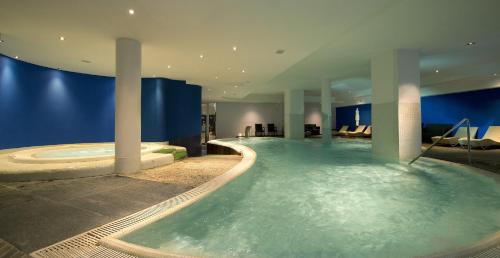a bathroom with a hot tub in a building at Grand Hotel Admiral Palace in Chianciano Terme
