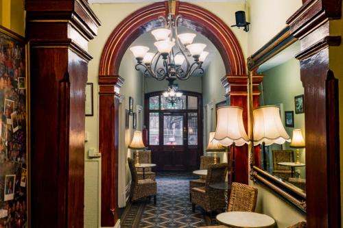 an archway in a hallway with chairs and a table at The Nunnery Accommodation in Melbourne