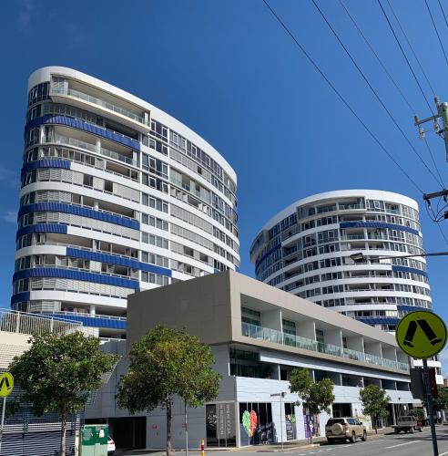 two tall buildings in front of a street at Tweed Ultima Apartments in Tweed Heads