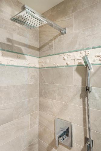 a shower with a glass shelf in a bathroom at Hotel Atwater in Avalon