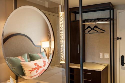 a room with a mirror and a chair with pillows at Hotel Atwater in Avalon