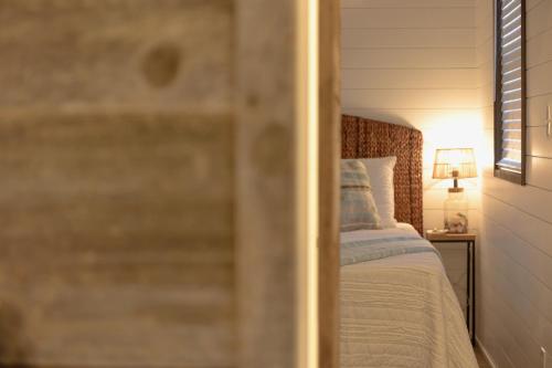 a bedroom with a bed and a lamp on a table at The Shoreline Container Home 12 min to Magnolia Silos and Baylor in Waco