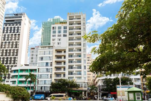 a tall white building with a sign on it at Regalia Nha Trang in Nha Trang