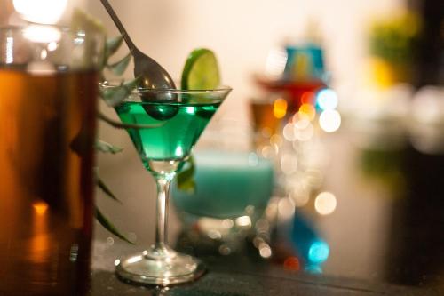 a green drink in a martini glass on a table at Regalia Nha Trang in Nha Trang