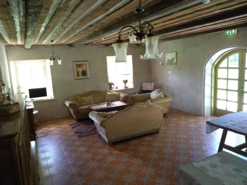 a living room with two couches and a table at Torma Puhkemaja ja Glämping in Torma