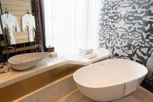 a bathroom with a white toilet and a sink at YOHO Hollywood Roosevelt Hotel in Macau