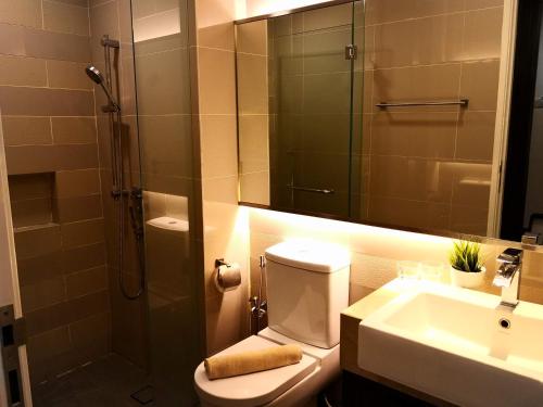 a bathroom with a shower and a toilet and a sink at One Bukit Ceylon by Homes Asian in Kuala Lumpur