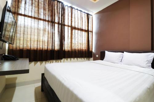 Postel nebo postele na pokoji v ubytování Hotel Istana Bungur