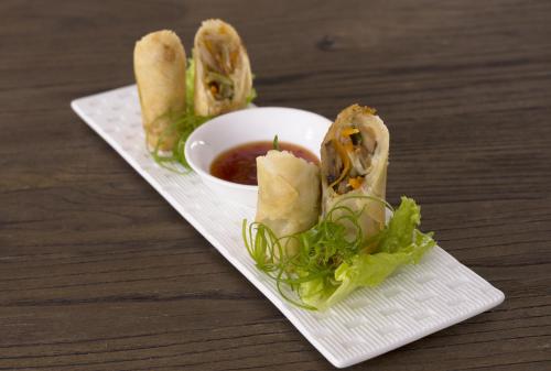 a plate of food with a bowl of dipping sauce at d'primahotel Panakkukang Makassar (Formerly Fave Panakkukang) in Makassar