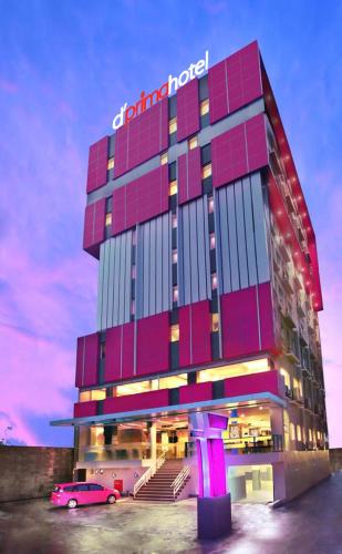 a building with a car parked in front of it at d'primahotel Panakkukang Makassar (Formerly Fave Panakkukang) in Makassar