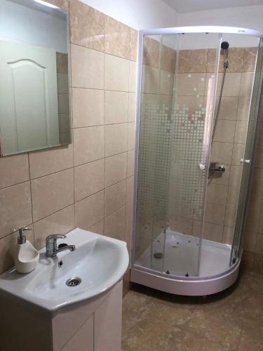 a bathroom with a shower and a sink and a sink at Casa Soral in Uriu