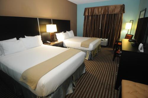 a hotel room with two beds and a desk at Holiday Inn Express Somerset by IHG in Somerset