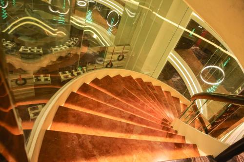 a view of a spiral staircase in a building at Bizz The Hotel in Rajkot