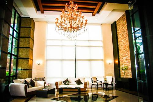 a large living room with a chandelier in a building at 42Grand Residence in Bangkok