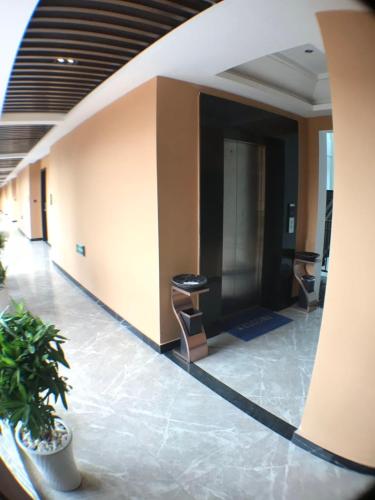 an empty lobby with a stools in a building at Le Chen Miiya Hotel in Sihanoukville