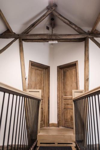 an empty room with wooden doors and stairs at Villa Vigor in Peer